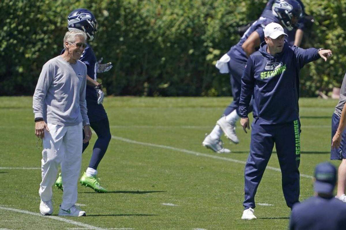 Pete Carroll (left) watches Shane Waldron, the new offensive coordinator for Russell Wilson and the Seahawks, direct the unit during minicamp June 19, 2021, at team headquarters in Renton.