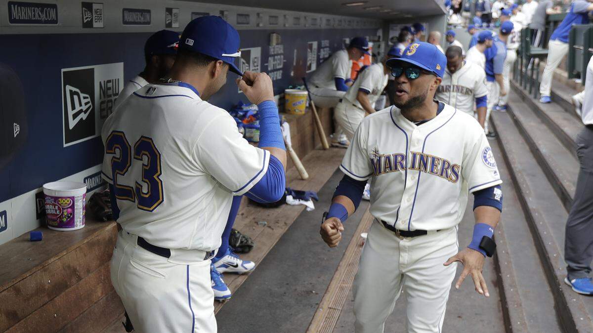 Seattle Mariners’ Nelson Cruz, left, greets Robinson Cano, right, before a baseball game against the Texas Rangers, Sunday, Sept. 30, 2018, in Seattle. (AP Photo/Ted S. Warren)