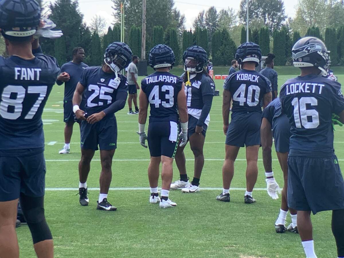 Rookie running back Kenny McIntosh (25), with tight end Noah Fant (87), rookie running back Wayne Taulapapa (43) from the University of Washington, running back Bryant Koback (40) and veteran wide receiver Tyler Lockett (16) on the fourth day of Seahawks training camp in Renton July 30, 2023.