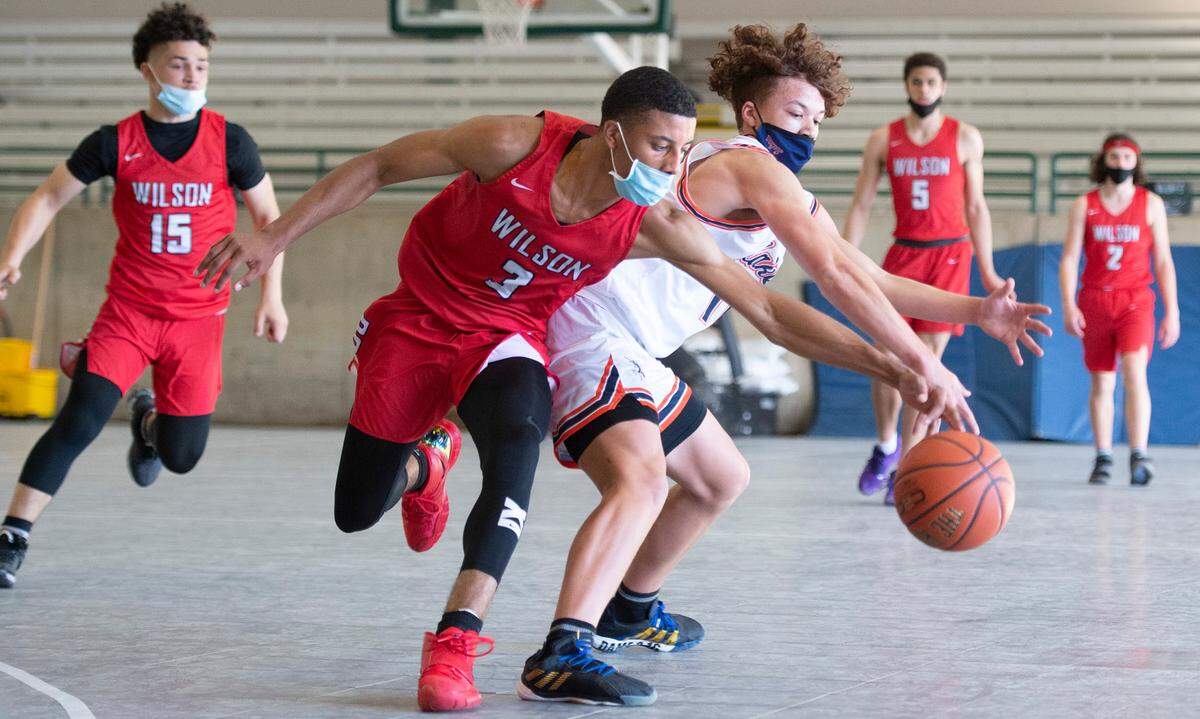 Wilson’s Cayden McDaniel steals the ball from Lakes’ Elijah McChriston during Thursday night’s high school basketball game on the arena courts at the Washington State Fairgrounds in Puyallup, Washington, on Thursday, May 13, 2021. Wilson won the game, 93-46.