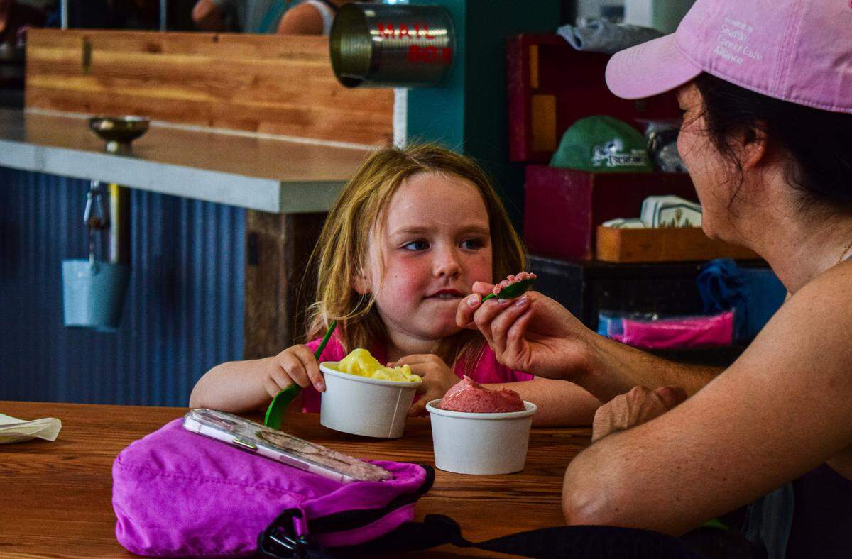 Mother and daughter Alix and Clara Lobaugh, fresh off a paddleboarding adventure, enjoyed a scoop of Dreamsicle ice cream and plumberry sorbet at the new IScreamery in downtown Gig Harbor on Thursday.
