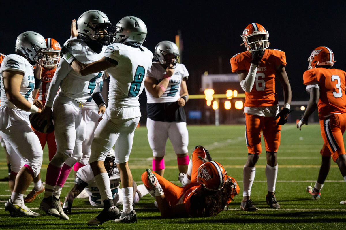 Spanaway Lake quarterback Dempsy James celebrates with receiver Jasiah Wagoner after James plowed into the endzone for the go-ahead touchdown late in the fourth quarter of a 3A PCL game against Lakes on Monday, Oct. 17, 2022, at Harry E. Lang Stadium in Lakewood, Wash.