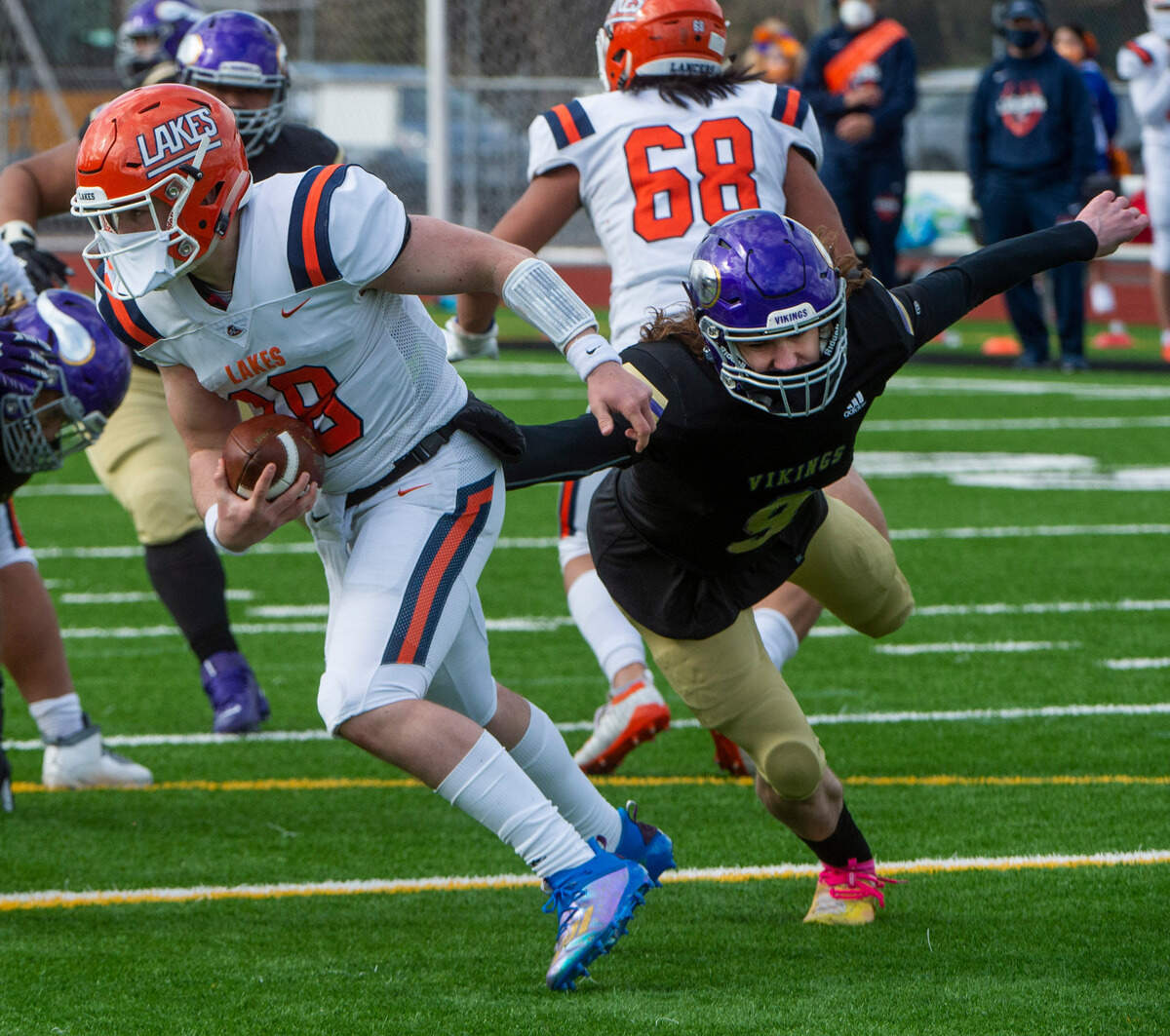 Puyallup linebacker Hayden Lovett pressures Lakes QB Justin Brennan. The Vikings rolled to a 44-16 victory over the Lancers at Sparks Stadium in Puyallup Saturday, Feb. 27, 2021.