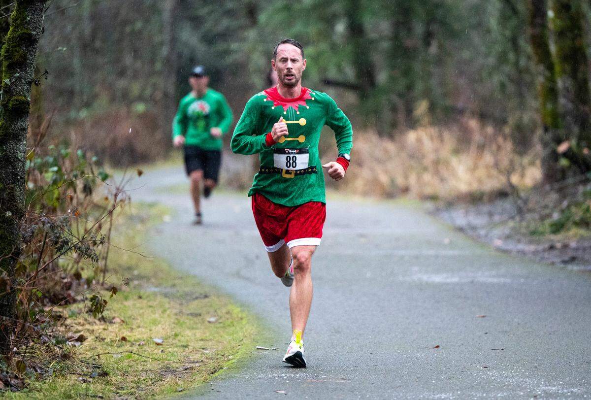 A runner nears the finish line during the 5th Annual Christmas Eve Ugly Sweater 5K on the Nathan Chapman Memorial Trail in Puyallup, Wash. on Dec. 24, 2022.