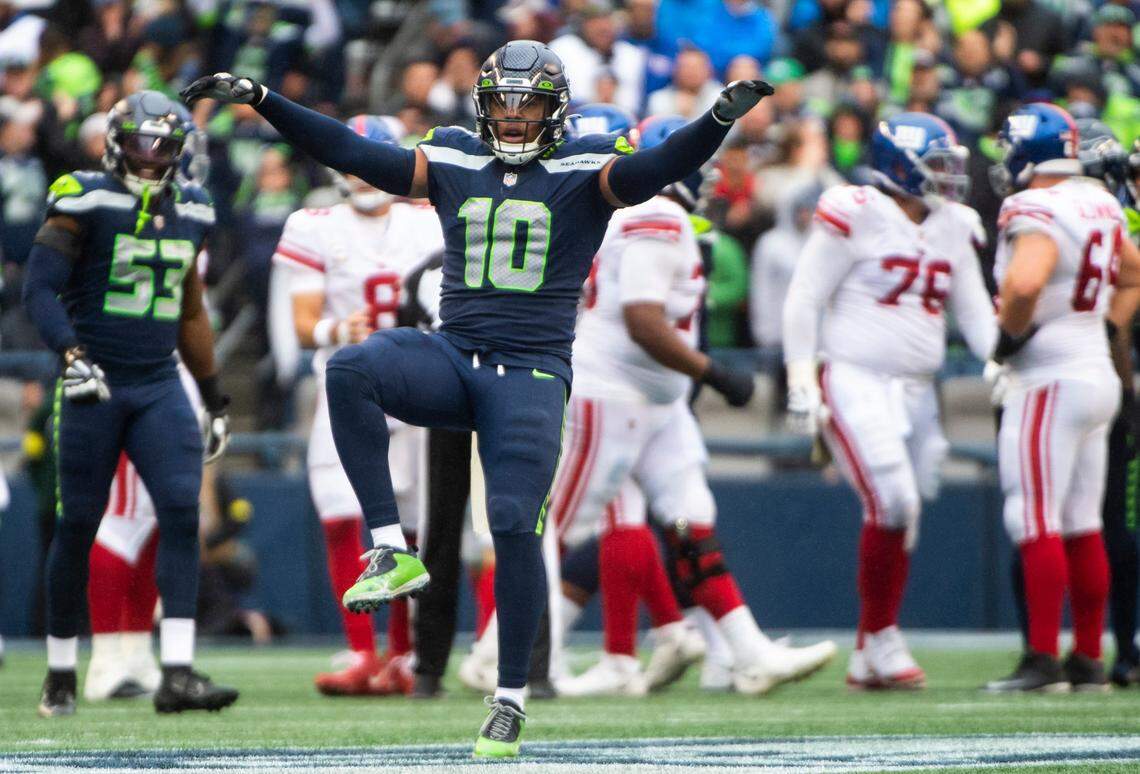 Seattle Seahawks linebacker Uchenna Nwosu (10) imitates a hawk while celebrating after a tackle was made against the New York Giants offense in the fourth quarter of an NFL game at Lumen Field in Seattle, Wash. on Oct. 30, 2022. The Seahawks defeated the Giants 27-13.