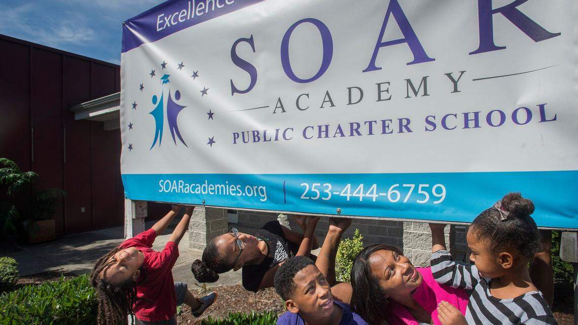 Roquesia Williams and her children (from left to right) Gesiah, Gehariii, Genai and Gervais stand outside SOAR Academy in July 2015. Williams was a triple pioneer at the time, as she had a child at each of Tacoma’s three new charter schools that opened that year.