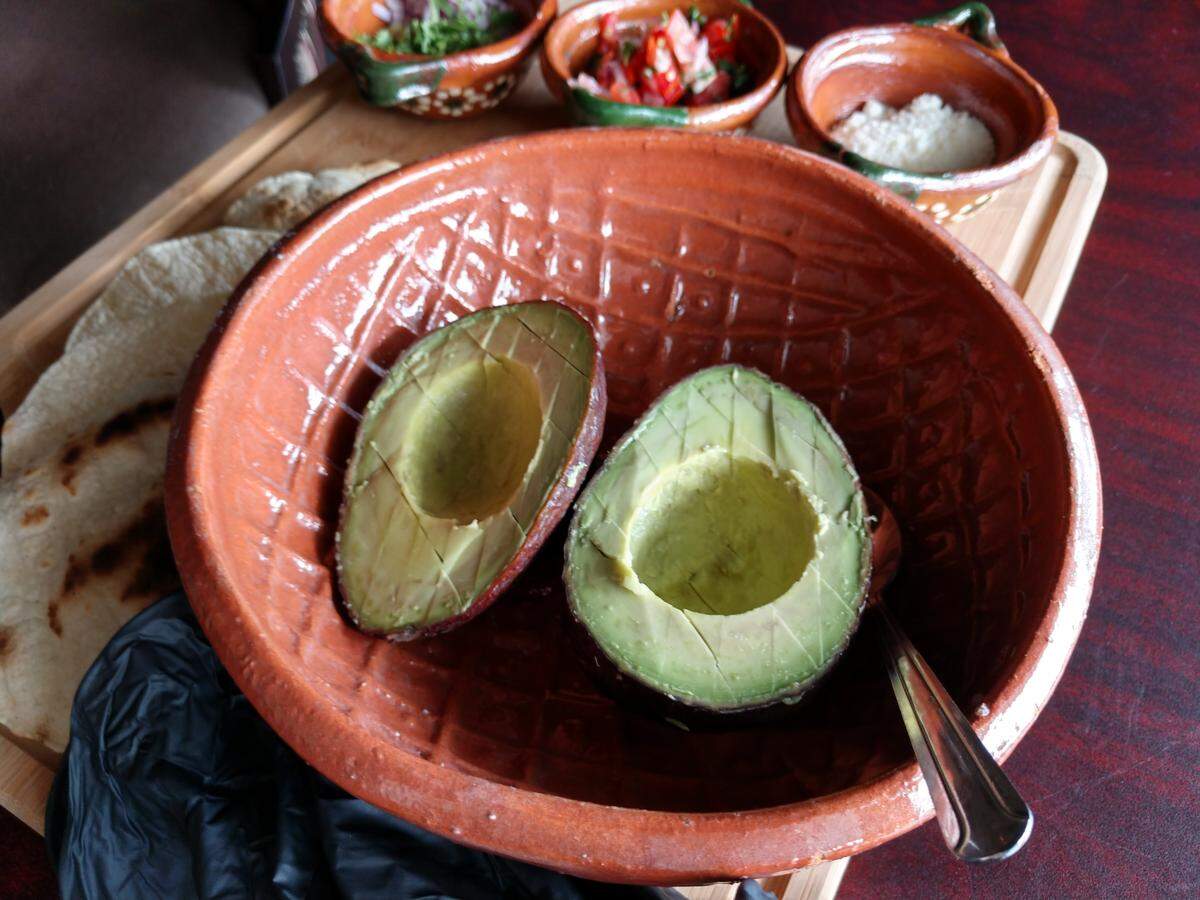 Fresh avocado halves wait to be turned into guacamole at Ta Carbon.
