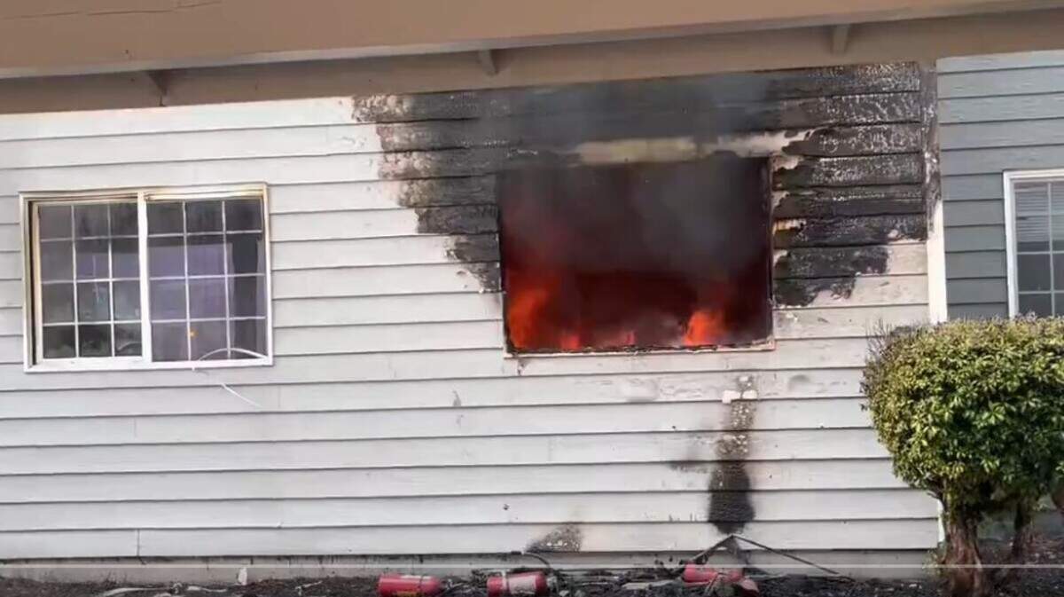 Flames erupt inside an apartment building on East Main Avenue in Puyallup Friday afternoon.