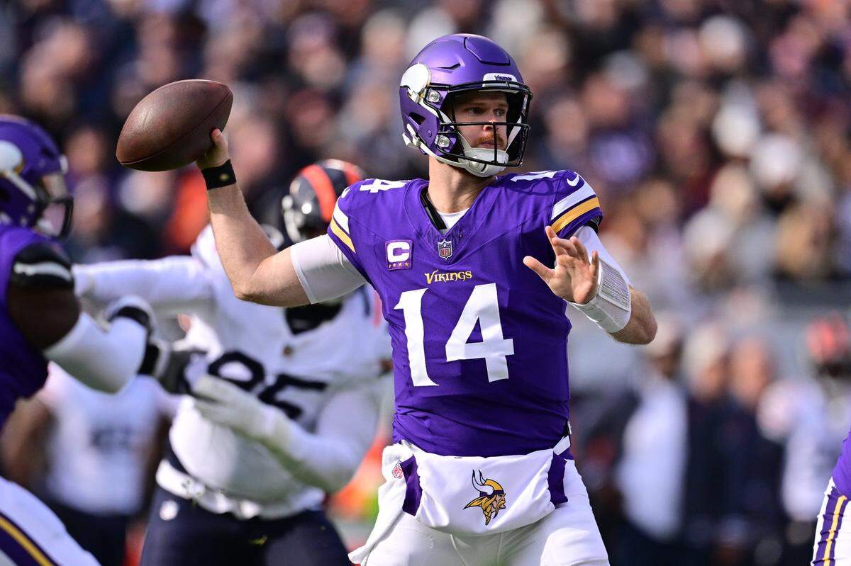 Nov 24, 2024; Chicago, Illinois, USA; Minnesota Vikings quarterback Sam Darnold (14) passes the ball against the Chicago Bears during the first quarter at Soldier Field. Mandatory Credit: Daniel Bartel-Imagn Images