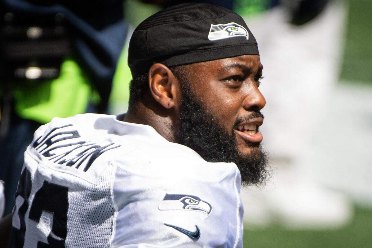 Branden Jackson sits on the bench before the start of the mock game. The Seattle Seahawks held a practice game at CenturyLink Field in Seattle, Wash., on Saturday, Aug. 22, 2020.