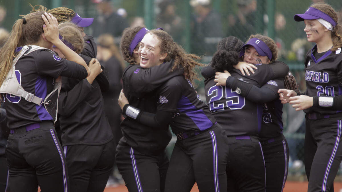 Garfield’s Nicola Simpson, center, and her teammates celebrate after the final out of their 3A State Finals Softball game at the Regional Athletic Complex in Olympia, Wash., May 25, 2019. Garfield defeated Yelm 10-4 to win the state title.  