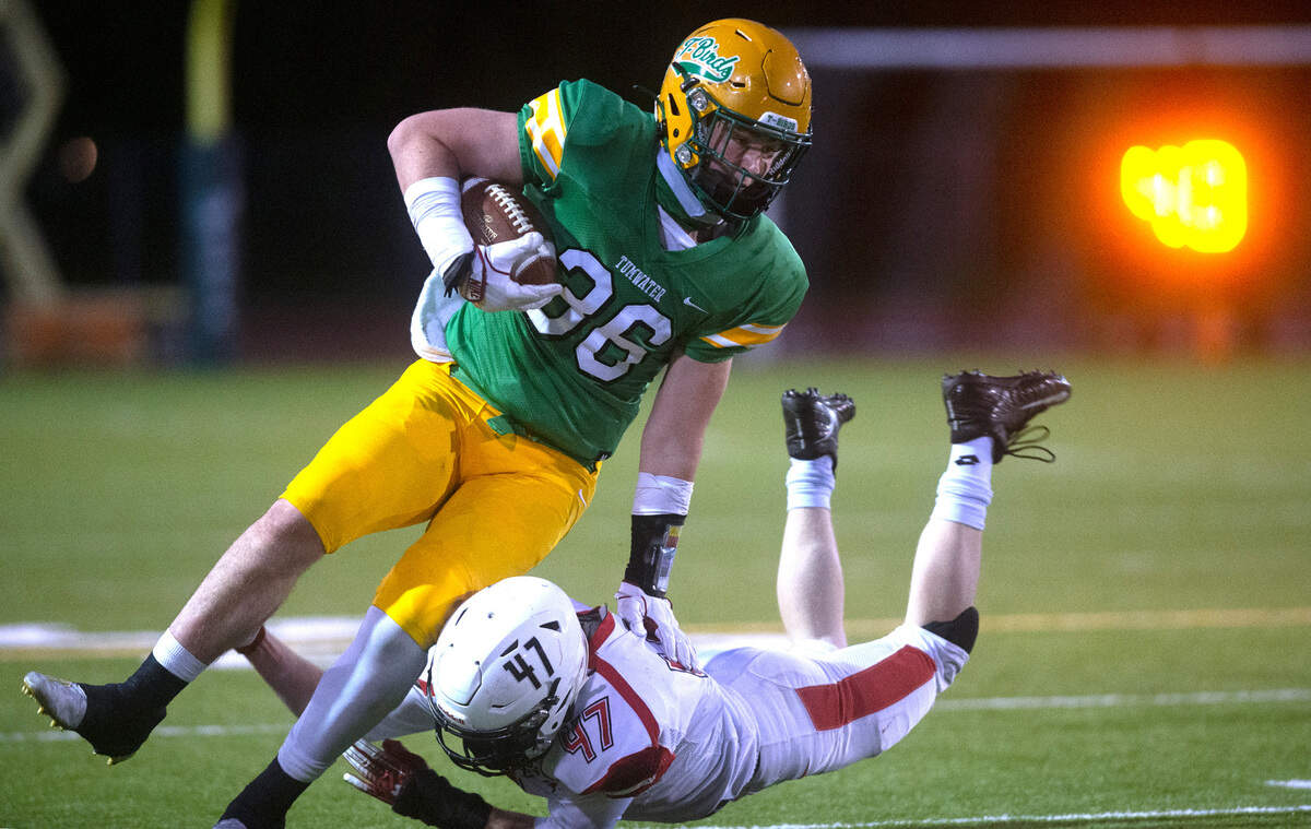 Tumwater tight end Austin Terry tries to fight off Steilacoom linebacker Austin Kinney during Saturday night’s high school football game at Tumwater District Stadium on Saturday, March 20, 2021.
