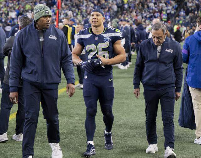 Seattle Seahawks running back Zach Charbonnet (26) comes off the field en route to the blue tent during the second quarter of the NFC Divisional Round game at Lumen Field, on Saturday, Jan. 17, 2026, in Seattle.