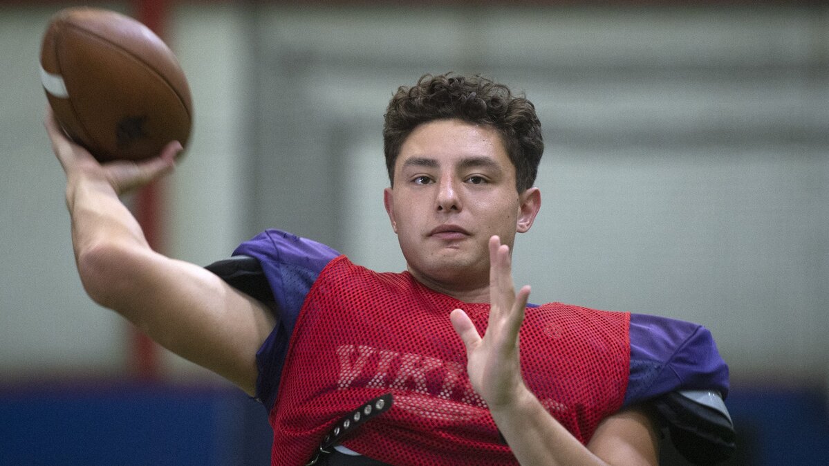 Puyallup senior quarterback Jacob Holcomb warms up during preseason football practice at New Level 360 indoor training center in Puyallup on Tuesday, Aug. 21, 2018.