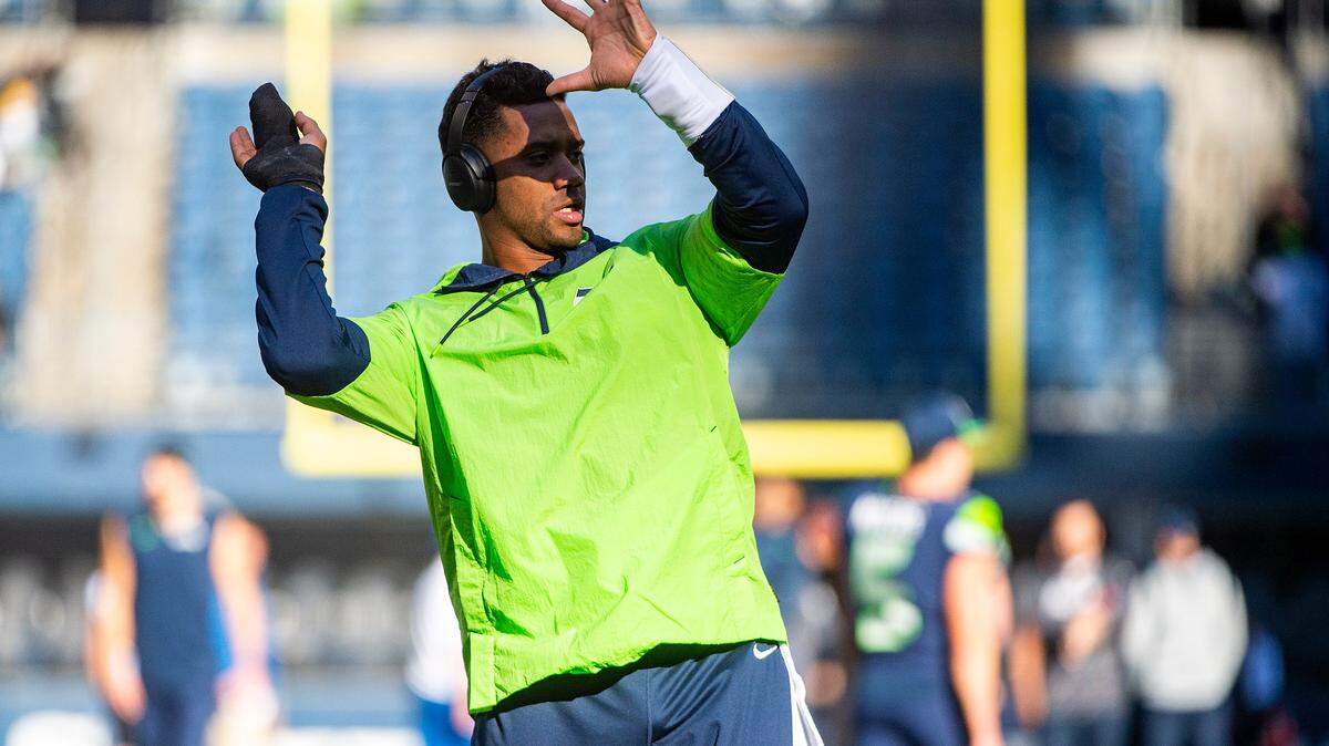 With a new wrap on his fingers, Seahawks quarterback Russell Wilson goes through the motions of throwing passes and running the offense prior to the start of Seattle’s game against Jacksonville on Sunday at Lumen Field in Seattle.