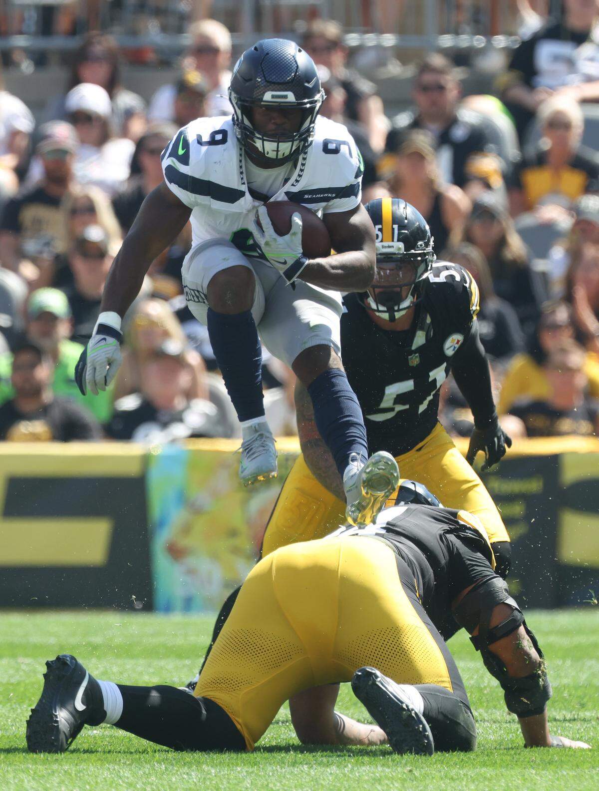 Sep 14, 2025; Pittsburgh, Pennsylvania, USA; Seattle Seahawks running back Kenneth Walker III (9) leaps over Pittsburgh Steelers defensive tackle Yaha Black (bottom) on a second quarter carry at Acrisure Stadium. Mandatory Credit: Charles LeClaire-Imagn Images