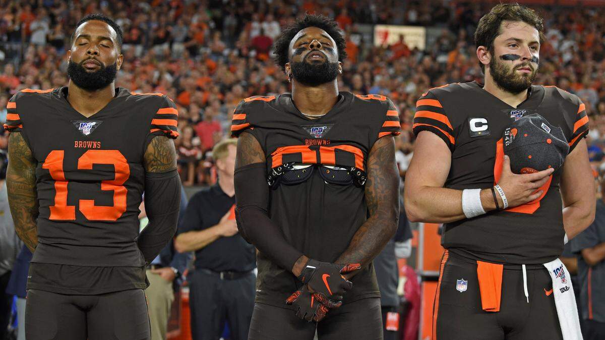 Cleveland Browns wide receiver Odell Beckham Jr., wide receiver Jarvis Landry and quarterback Baker Mayfield stand for the national anthem before an NFL football game against the Los Angeles Rams, Sunday, Sept. 22, 2019, in Cleveland. The Rams won 20-13. (AP Photo/David Dermer)