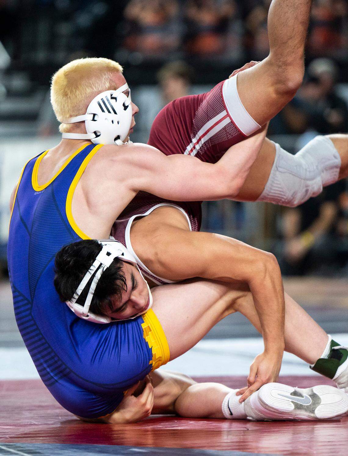 South Kitsap Mitchell Neiner flips on top of Issaquah Dash Riley during the 138-pound 4A quarterfinal match at Mat Classic XXXIV on Friday, Feb. 17, 2023, at the Tacoma Dome in Tacoma, Wash. Neiner defeated Riley 24-9.