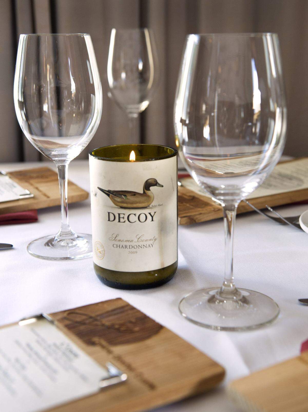 Empty bottles of wine have been fashioned into votives at JW Restaurant in Gig Harbor.