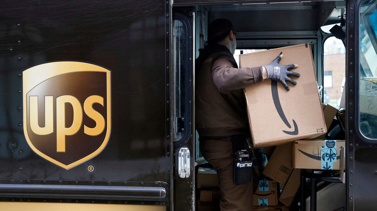 A UPS driver prepares to deliver packages, Wednesday (Dec. 19), in Baltimore. UPS expects its busiest return day to fall before Christmas for the first time.