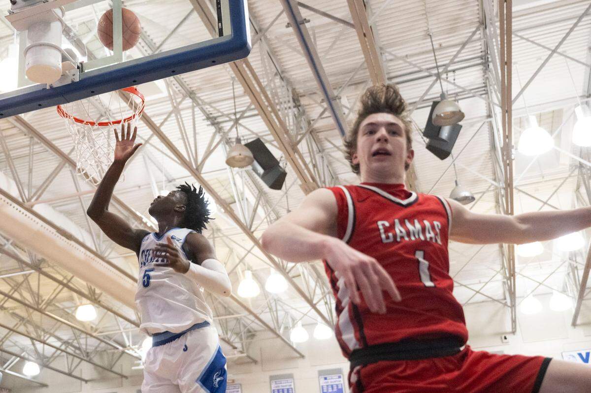 After using a pump fake, Curtis guard Zoom Diallo (5) gets an easy bucket as Camas guard Beckett Currie (1) blows by during the fourth quarter of a District 3/4 semifinal game on Thursday, Feb. 16, 2023, at Curtis High School in University Place, Wash.