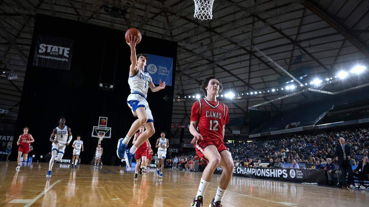 Curtis’ Tyce Paulsen puts up a breakaway lay up by Camas defender Jace VonVoorhis during their state quarterfinal game at the WIAA state basketball tournament in the Tacoma Dome in Tacoma, Washington, on Wednesday, March 1, 2023. Curtis won the game, 73-46