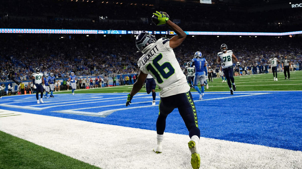 Seattle Seahawks wide receiver Tyler Lockett (16) celebrates after catching a 3-yard touchdown pass during the second half of an NFL football game against the Detroit Lions, Sunday, Sept. 17, 2023, in Detroit. (AP Photo/Paul Sancya)
