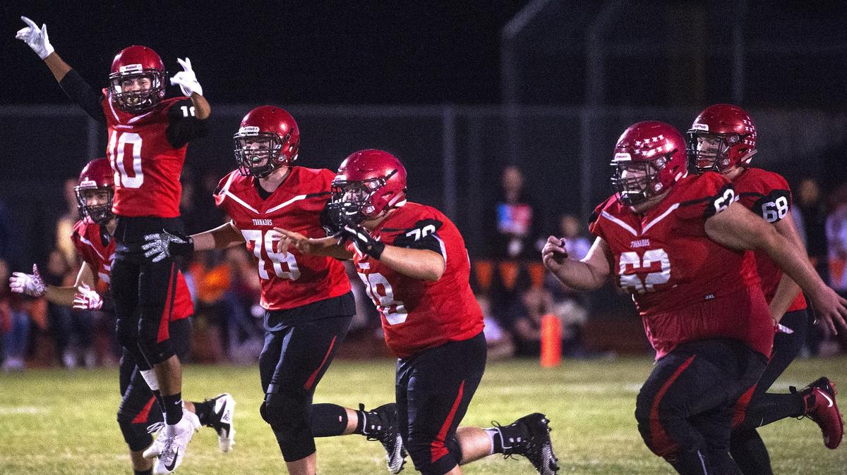 Yelm running backs (from left) Richard Romo, Sylas Franklin, and offensive linemen Dylan Jemtegaard, Hunter Mohl, Doug Thompson and Brandley McGannon celebrate teammate Derrick Platt’s fumble recovery and 50-yard return for a touchdown during Friday night’s football game against Capital at Yelm High School on Sept. 28, 2018.