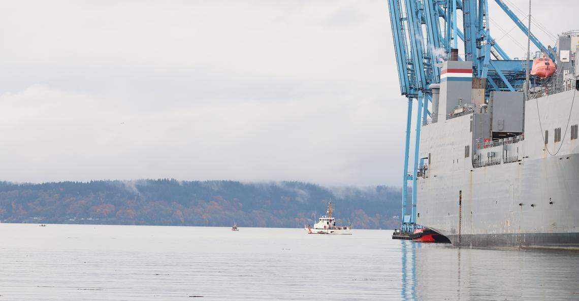 A small vessel carrying water warrior allies, left, floats near a Tacoma police boat and a U.S. Coast Guard boat that guard the MV Cape Orlando, a U.S. military ship , on Monday, Nov. 6, 2023.
