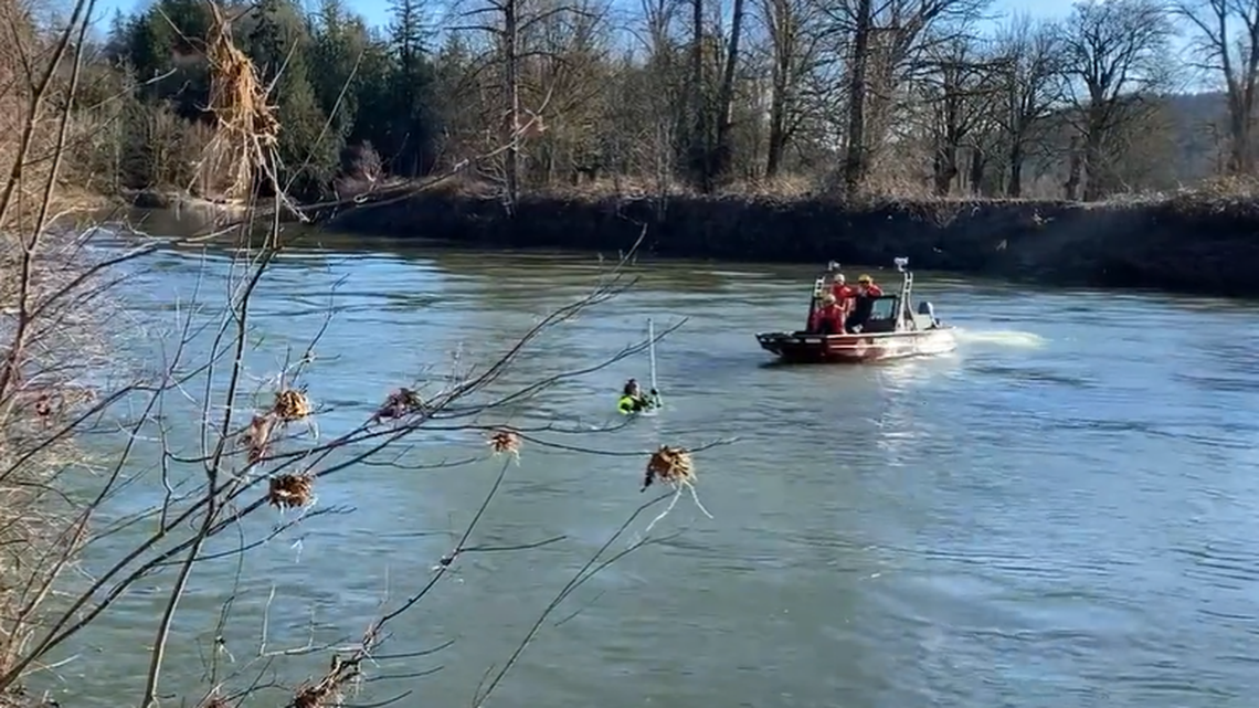 Rescuers are looking for a missing woman and her 6-year-old son in the Snoqualmie River in this Jan. 9, 2022, photo after a 35-year-old man crashed the vehicle, Washington State Patrol said. The man and his 8-month-old daughter survived.