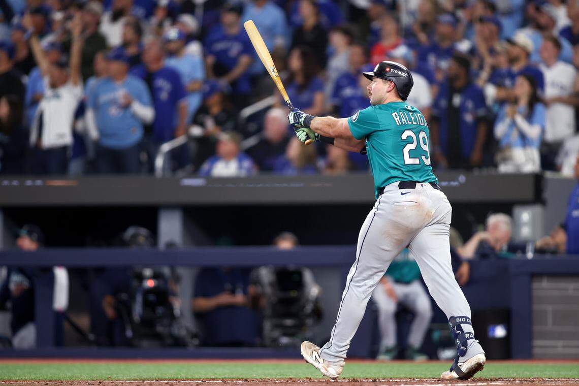 TORONTO, ONTARIO - OCTOBER 12: Cal Raleigh #29 of the Seattle Mariners hits a solo home run during the sixth inning against the Toronto Blue Jays in game one of the American League Championship Series at Rogers Centre on October 12, 2025 in Toronto, Ontario. (Photo by Cole Burston/Getty Images)
