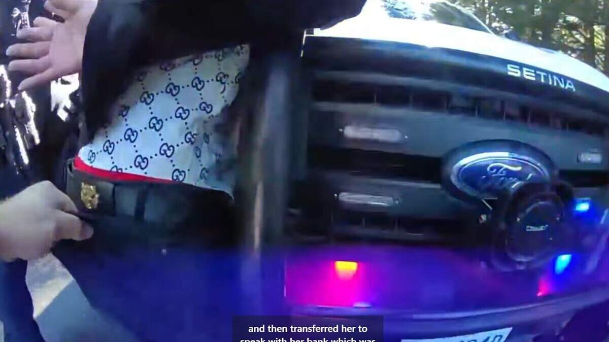 In this image from body cam video, Jingbing Xue, 44, of Federal Way is arrested by the Pierce County Sheriff’s Department after he attempted to collect money from a scam victim in Ashford Jan. 17. A fake badge can be seen on his belt.