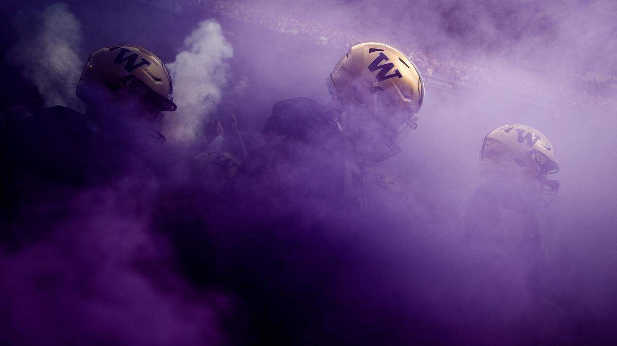 The Huskies take the field through their signature purple smoke before the game. The Washington Huskies played the USC Trojans in a NCAA football game at Husky Stadium in Seattle, Wash., on Saturday, Sept. 28, 2019.
