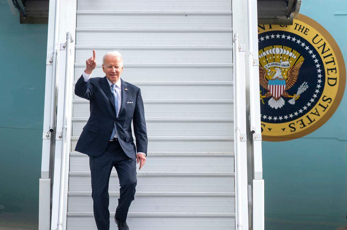 President Joe Biden waves to the media as he walks off of Air Force One on Thursday, April 21, 2022, at Sea-Tac International Airport .