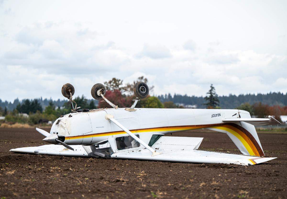 A two-seater plane crash landed upside down in a dirt field east of Pioneer Way and west of 66th avenue in Waller, Wash. on Oct. 26, 2022. The pilot was the only occupant of the plane and he was not injured.