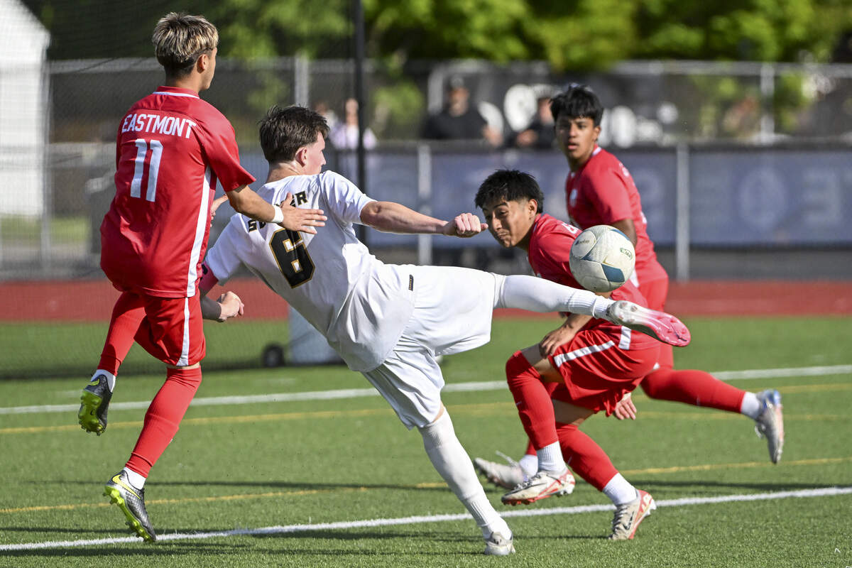 Eastmont defenders surround Sumner’s Aiden Vannoy (6) as he crosses the ball into the net for Sumner’s first goal on Saturday, May 30, 2026, during the 2026 4A Boys Soccer Championships final in Puyallup, Wash.