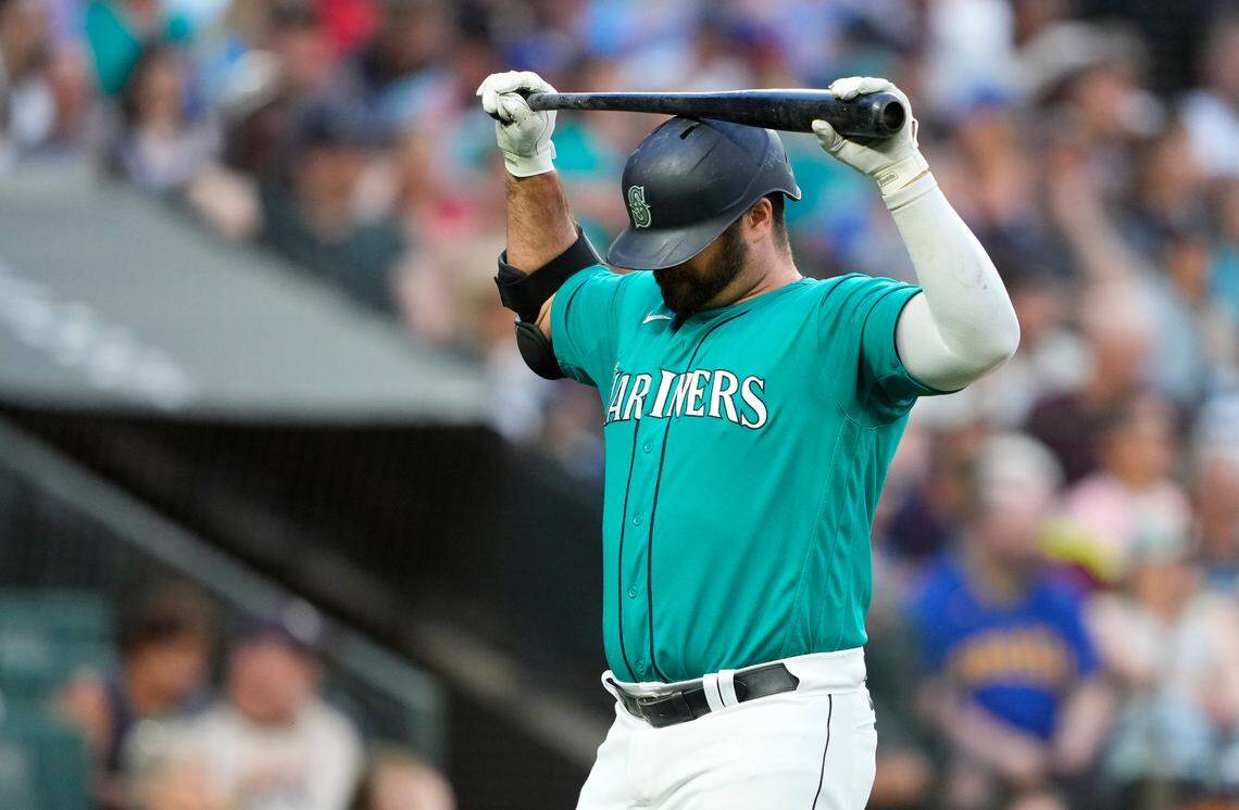 Seattle Mariners’ Mike Ford holds his bat above his head after striking out against the Detroit Tigers during the seventh inning of a baseball game Saturday, July 15, 2023, in Seattle. (AP Photo/Lindsey Wasson)