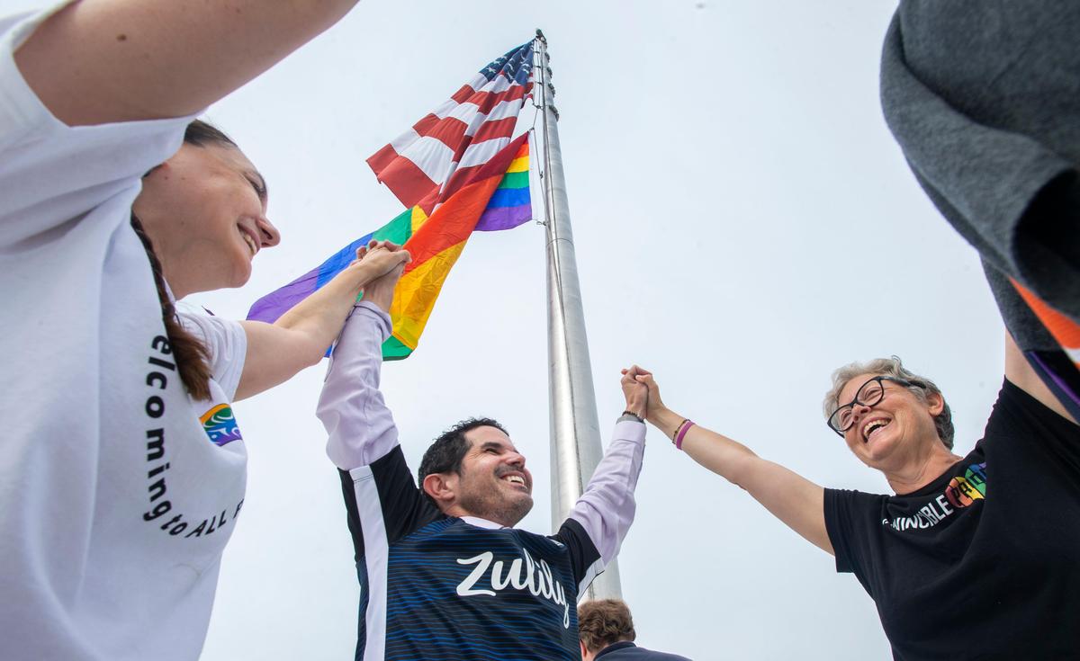 Puyallup Tribal Council member Annette Bryan, left, Tacoma City Council member Ryan Mello, and state Rep. Laurie Jinkins celebrate after the first-ever raising of the iconic rainbow gay pride flag over the Tacoma Dome on Tuesday, July 9, 2019.