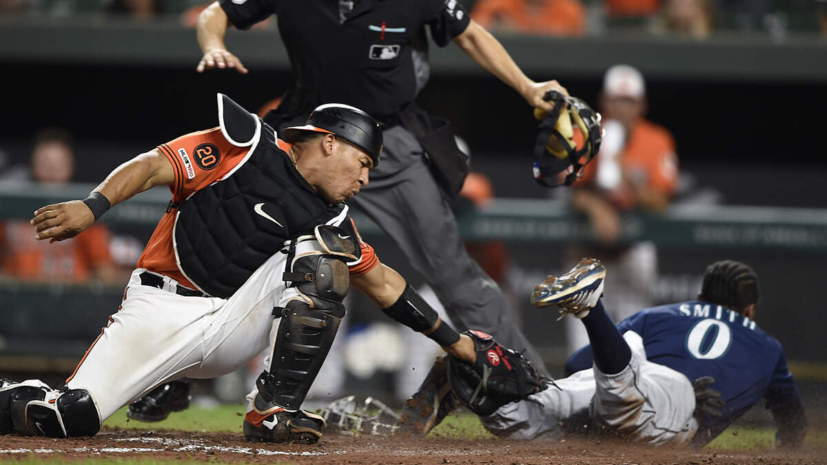 Seattle Mariners’ Mallex Smith slides safely into home for the go-ahead run as Baltimore Orioles catcher Pedro Severino tries to make the tag during the 13th inning of a baseball game Saturday, Sept. 21, 2019, in Baltimore. The Mariners won 7-6.