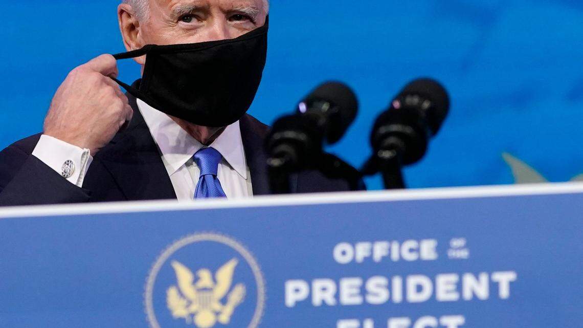 President-elect Joe Biden removes his mask as he arrives to speak after the Electoral College formally elected him as president, Monday, Dec. 14, 2020, at The Queen theater in Wilmington, Del. (AP Photo/Patrick Semansky