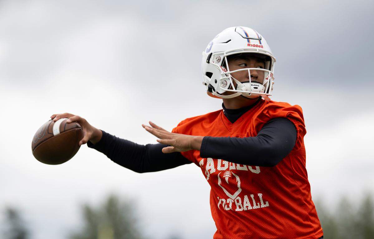 Graham-Kapowsin quarterback throws a pass during a football practice at Graham-Kapowsin High School, on Thursday, Aug. 22, 2024, in Graham, Wash.
