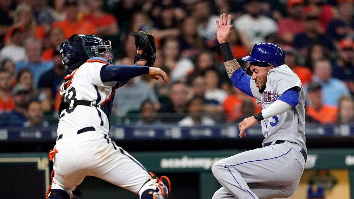 Houston Astros catcher Robinson Chirinos (28) reaches to tag Seattle Mariners’ J.P. Crawford during the fourth inning of a baseball game Friday, June 28, 2019, in Houston. Crawford was out at home plate. (AP Photo/David J. Phillip)