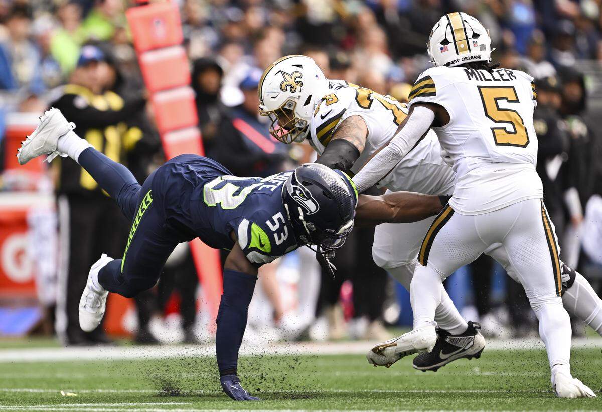 Seattle Seahawks linebacker Boye Mafe (53) wraps up New Orleans Saints running back Kendre Miller (5) during the first quarter of the game at Lumen Field, on Sunday, Sept. 21, 2025 in Seattle.