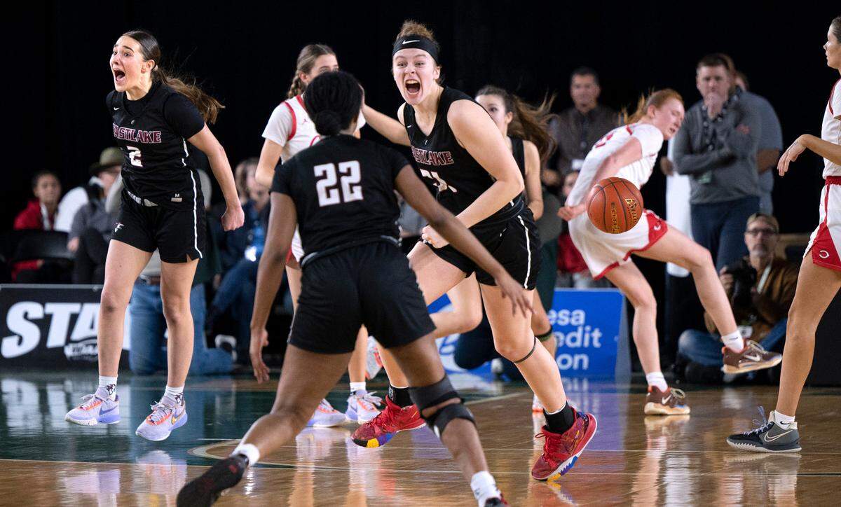 Eastlake’s Sofia Aluas (2), Kaylia Jackson (22), and Ava Schmidt celebrate as time expires in their 48-41 victory over the Camas Papermakers in the 4A girls state title game at the WIAA state basketball tournament in the Tacoma Dome in Tacoma, Washington, on Saturday, March 4, 2023.