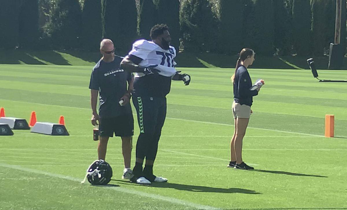 Former Philadelphia Eagles All-Pro tackle Jason Peters, 41, gets a trainer’s help with pads then stretching at the start of his first practice with the Seahawks Sept. 13, 2023.