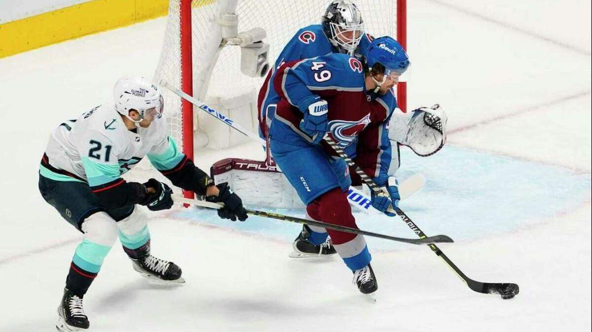 Colorado Avalanche defenseman Samuel Girard (49) clears the puck near Seattle Kraken center Alex Wennberg (21) during the first period in Game 2 of a first-round Stanley Cup playoff series Thursday, April 20, 2023, in Denver.