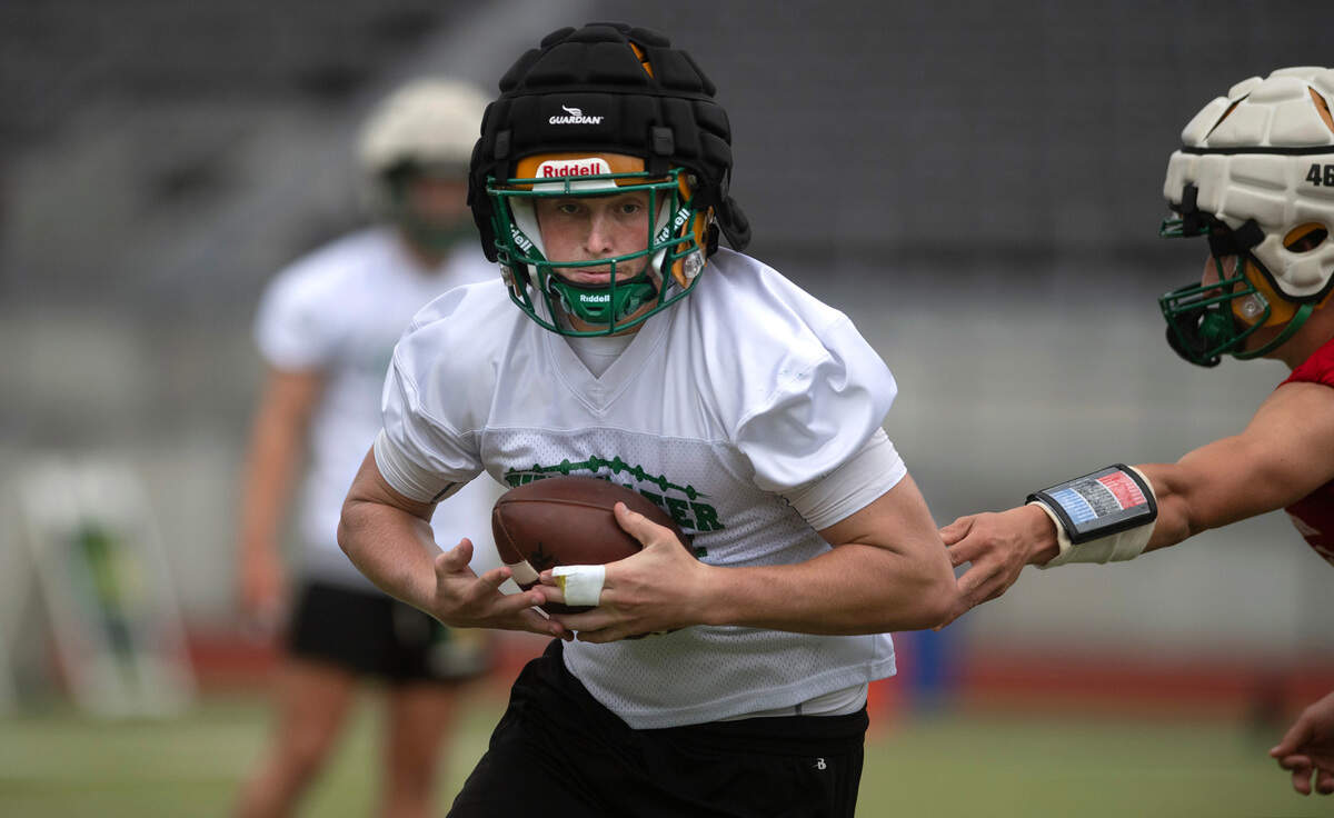 Tumwater’s Beckett Wall takes a handoff during preseason football practice at Tumwater District Stadium in Tumwater, Washington, on Thursday, Aug. 22, 2024.