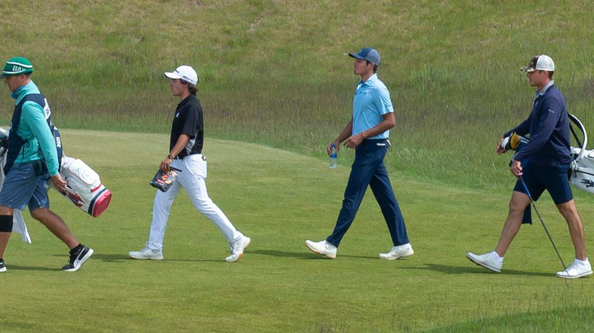 Leopoldo Herrera III (second from left), Kiko Francisco Coelho and Sam Meek march up the second fairway during the finals match of the USGA Amateur Four Ball Championship at Chambers Bay Golf Course in University Place, Washington, on Wednesday, May 26, 2021.