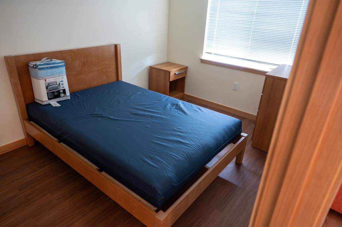A furnished unit is prepared for a new resident at the Lily V. Brazill New Life Apartments and includes items to help set up the space, like a bedding set, plates, and other toiletries, on Wednesday, May 7, 2025, in Tacoma, Wash.