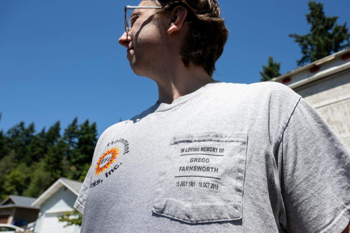 Travis Kienholz wears a shirt honoring Gregg Farnsworth, a former owner of the Entertainment Fireworks Inc., who Kienholz worked with for several years on the annual fireworks display for Vashon Island. Kienholz wears the shirt as he and his father prepare for the upcoming Red White and Kaboom fireworks show on Tuesday, July 1, 2025, in Puyallup.